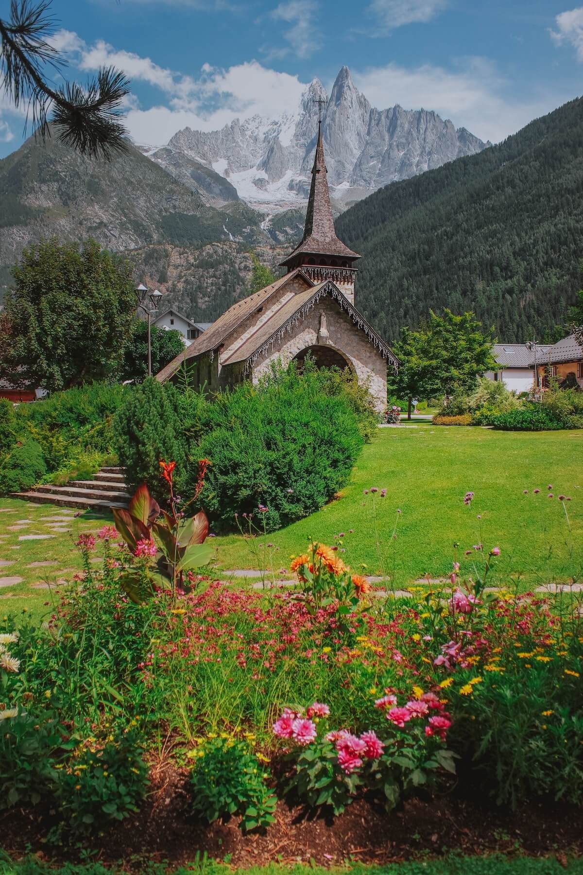 Church surrounded by mountains and grass